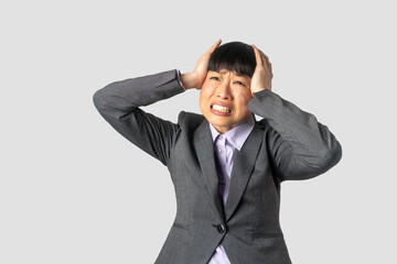 Woman overwhelmed with stress and concern, confusion and doubt, hands to head, on grey background...