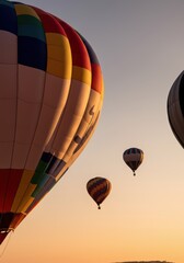 Colorful hot air balloons flying at sunset, creating a stunning visual display
