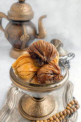 Baklava. Traditional Middle Eastern sweets served with an ornate teapot in an elegant setting