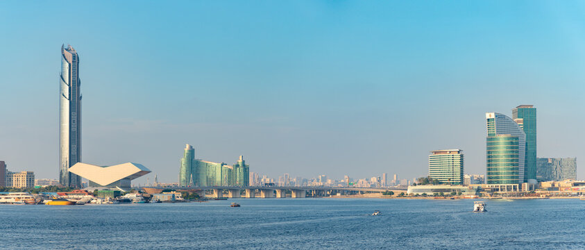 Dubai, United Arab Emirates - November 5, 2023: A picture of the wide section of the Dubai Creek, in the east, with large modern buildings on both margins.