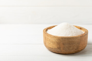 Aromatic vanilla sugar. Vanilla pods. Vanilla sticks, brown and white sugar in a bowl on a textured background. Vanilla flowers, spices and herbs for desserts and baking. Space for text. Copy space