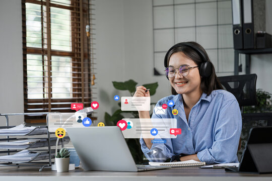 Young freelance woman using laptop checking social media. Online sales, digital marketing, advertising, product advertisement, promoting products or services via digital tools.