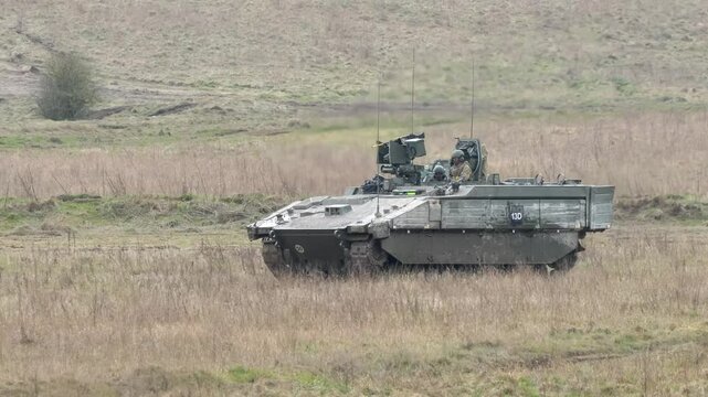 a British army General Dynamics Ajax Ares tank being tested across muddy ground