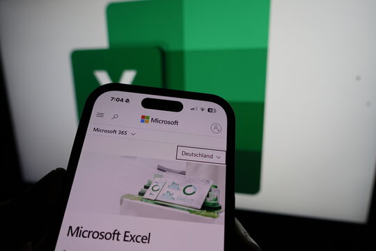 Kiel, SH, Germany March 20 2025: Smartphone displaying Microsoft Excel website in front of company logo on a monitor, showcasing digital tools for productivity.