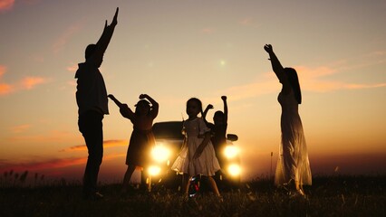 Family party in nature by car, children kids parents dancing together enjoying summer time fun company. Kids sons daughters mom dad having good time with music by car big family travelling road trip