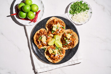 Traditional Mexican Tacos al Pastor with Fresh Lime and Salsa on a Rustic Table