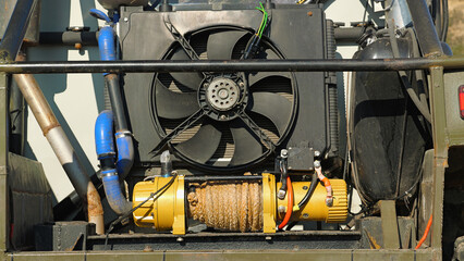 Close-up of the rear of a custom-built off-road vehicle. The vehicle is equipped with a large...