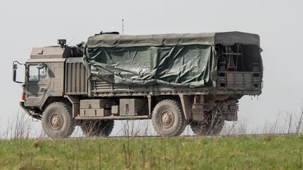 close-up of a MAN SV 4x4 utility truck moving along a dirt track in countryside