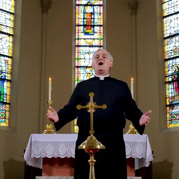 Catholic priest sings sacred music in church