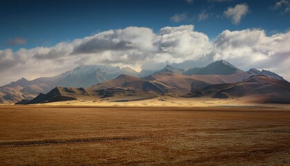 silty mountain range behind a flat plain with clouds hills earthy