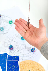 Pendulum fortune telling and astrology. Selective focus.