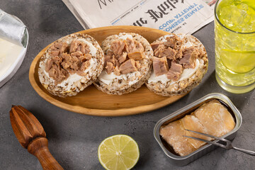 Tuna sandwiches on a table next to lemonade and beer, in a modern interior design
