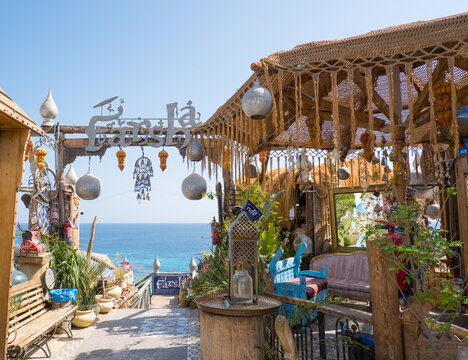 Sharm el-Sheikh, Egypt - March 12, 2025: Entrance to the popular Farsha cafe on the shores of the Red Sea in the Hadaba area. Seating area with arch, eclectic decor.