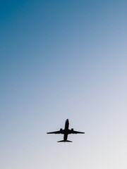 Jet plane soaring high against a clear blue sky, showcasing the beauty of modern air travel and the boundless expanse of the atmosphere, embodying freedom and adventure. limitless aerial exploration
