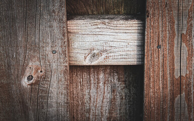a close-up of weathered wooden planks arranged perpendicular for a fence. beautiful wood with reclaimed patina rustic background. board on board.