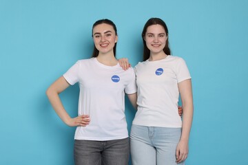 Portrait of smiling volunteers on light blue background