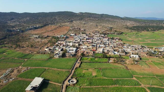 Aerial view of village between hills in Chakwal, Pakistan.