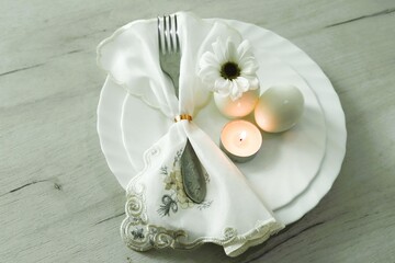 Easter still life with eggs, candle and flower