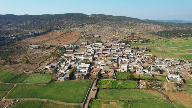 Aerial view of village between hills in Chakwal, Pakistan.