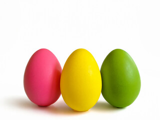 Three different colored eggs are neatly lined up in a row formation