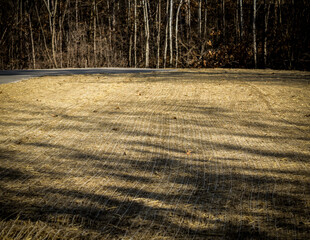lawn, field or park area covered with biodegradable erosion control blanket or mat. to stabilize...