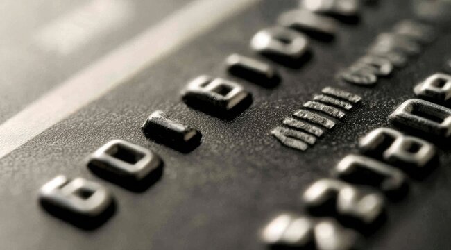 Embossed Digits on Card - A Close-Up of Financial Security and Banking Technology - Powered by Adobe