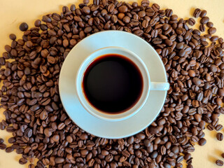 Enjoy a freshly brewed cup of coffee, beautifully surrounded by rich roasted coffee beans