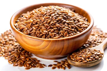 A wooden bowl filled with brown flax seeds sits on a white surface, with some seeds scattered around it.