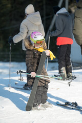 Winter adventure unfolds at a snowy ski resort as a young skier prepares for an exciting descent...