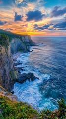 Scenic view of rocky coastline with sunset over cliffs