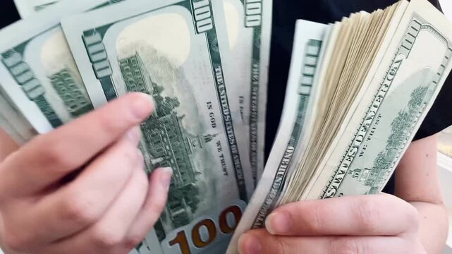 counting 100 dollar bills, stack of dollars