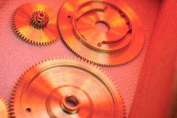 Intricate details of clockwork gears illuminated by warm light enhance the beauty of mechanical...
