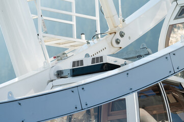 Exploring the mechanics of a towering ferris wheel as it spins gracefully under a bright sky