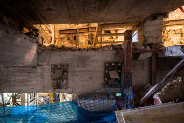 Construction site with exposed concrete and safety netting