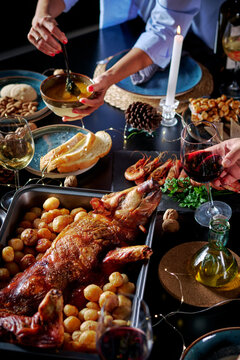 Elegant holiday dinner with roasted suckling pig and wine
