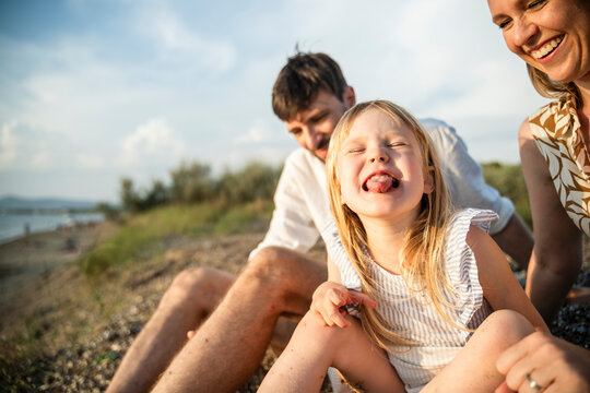 Happy family enjoying sunny day on the Italian beach
