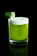 Pisco sour cocktail in a glass on a black background