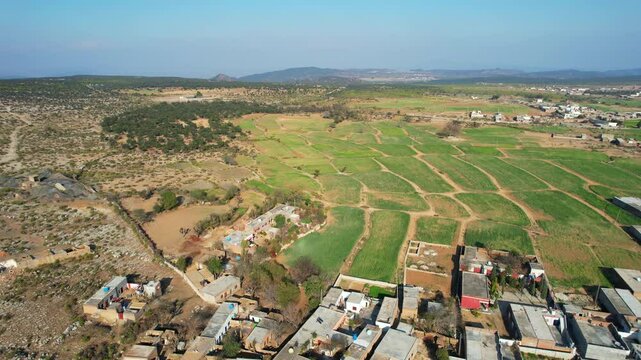 Aerial view of village between hills in Chakwal, Pakistan.