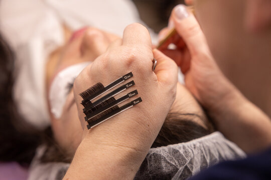 Beauty technician applying eyelash extensions with precision