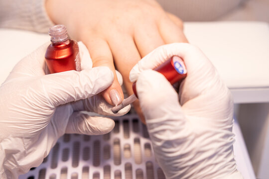 Professional manicure with nail polish application in a beauty salon