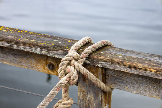 Close-up of weathered dock and knotted rope in Hoonah, Alaska