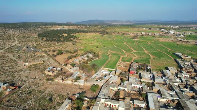 Aerial view of village between hills in Chakwal, Pakistan.