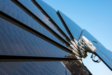 Smart solar flower photovoltaic panels against blue sky. Renewable energy source	

