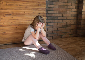 The child is crying, Unhappy child sitting on the floor High quality photo