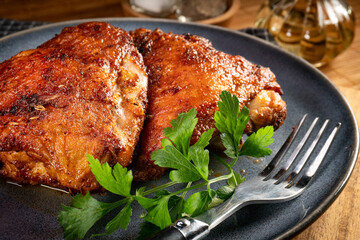 Two baked pieces of chicken.