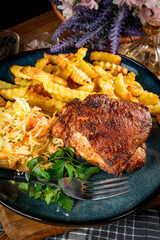 Crispy roasted chicken piece with french fries and salad.