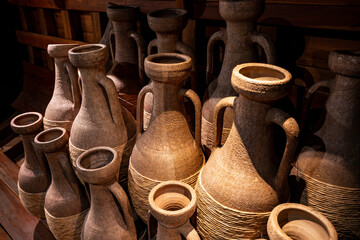 Ancient Etruscan Amphorae with Rope Wrapping in Rustic Museum Display