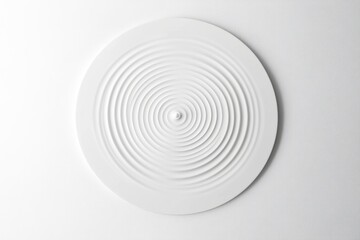 Obraz premium A macro shot of a droplet creating ripples in white liquid against a pure white background highlighting fluid dynamics and minimalist beauty with serene elegance