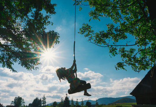 Child silhouette in a swing