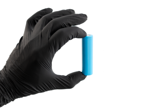 Hand in glove holds light blue rechargeable lithium-ion battery type 18650 for electrical appliances and devices, on isolated background, with space for text.